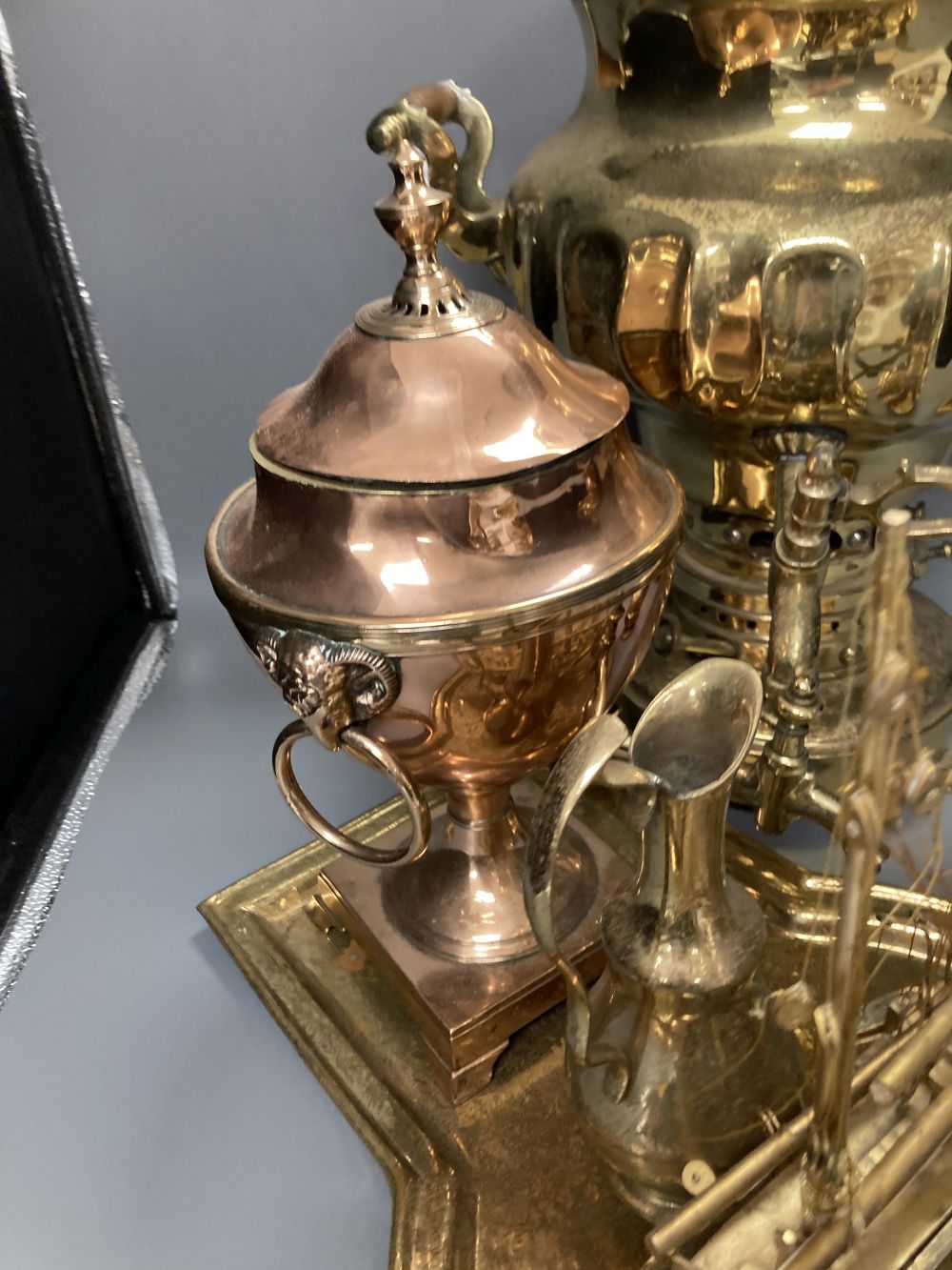 A Russian brass samovar and stand, height 47cm, a copper tea urn, a brass jug and a pair of champleve mugs